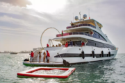 Guests enjoying water activities from a luxury yacht with the Dubai Marina skyline.