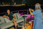 Three guests enjoying drinks on a luxury yacht during a sunset cruise