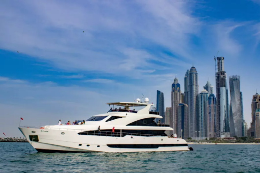 Luxury yacht cruising near Dubai skyscrapers