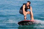 Man balancing on an Efoil board over the water.