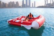 A couple preparing for a thrilling Fly Fish ride in Dubai waters.