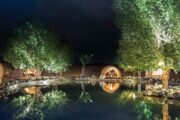 Scenic desert retreat with illuminated cabins under a starlit sky.