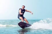 Man Riding a Jet Board Along Gentle Waves