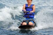 Young boy learning to kneeboard in a safe and scenic environment