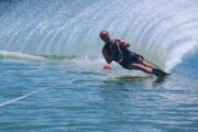 Water skier cutting through waves during a slalom ride