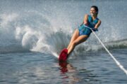 Woman gracefully water skiing on a single ski in Dubai