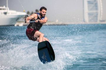 Man Wakeboarding in Dubai with Burj Al Arab in Background