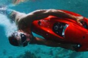 Man diving underwater with a red Seabob in Dubai