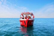 Modern speed boat cruising near the Dubai skyline.