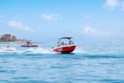 Red speed boat with passengers on the calm waters of Dubai