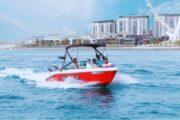 Red and white speed boats racing across the blue waters in Dubai