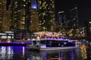 Houseboat cruising at Dubai Marina with skyscrapers in the background