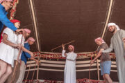 Visitors enjoying a falconry experience in a desert setting