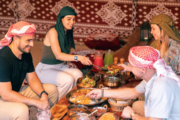 Group sharing a traditional Bedouin meal in a desert camp.