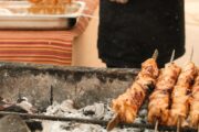 Freshly grilled skewers of Middle Eastern kebabs over a traditional charcoal fire.