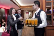 Waiter serving welcome drinks to guests on a Dubai yacht.