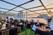 guests enjoying an open-air dining experience on a yacht in Dubai.