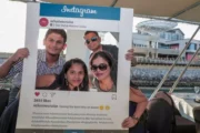 A family posing with an Instagram frame on a Dubai marina cruise.