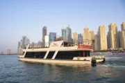 Modern yacht with Dubai skyscrapers in the background