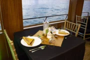 Elegant dinner table setup with a view of the sea