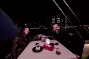 Elegant table setup for two with a waterfront view aboard a yacht.