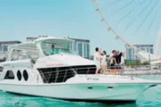 A luxury yacht docked near Ain Dubai Ferris wheel.