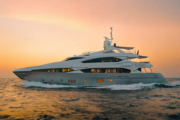 Evening view of Sunseeker superyacht glowing on the water