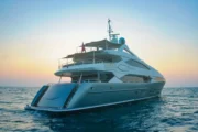 Superyacht cruising during golden hour near Dubai Harbour