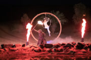 Nighttime fire and acrobatics show in the desert.