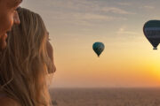 Couple enjoying hot air balloons at sunset