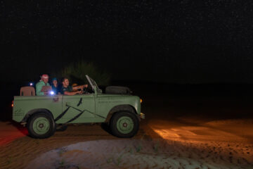 Night safari in a vintage jeep under a starry sky