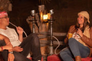 Group sharing shisha and coffee in a desert camp.