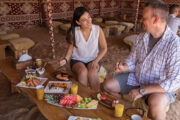 Guests enjoying a traditional breakfast in a Bedouin tent.