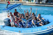 speed boats with excited passengers in front of Atlantis, The Palm.