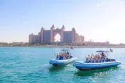 Tourists posing on a speedboat in front of Atlantis, The Palm.