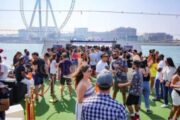 Guests enjoying a rooftop party on a yacht near Ain Dubai