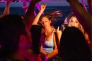 Close-up of women dancing during a yacht party with neon lights