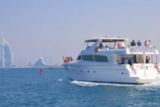 Yacht sailing near the Burj Al Arab with a lively group on board