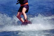 Close-up of a wakeboarder’s feet carving through the water in Dubai