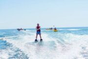 Man leaning sharply while performing mono-skiing trick on water