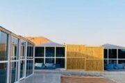 panoramic view of desert chalets with a swimming pool.