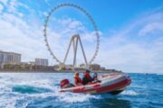 Family enjoying a self-drive boat ride with Ain Dubai in the background.