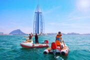 Group enjoying self-drive boats with Burj Al Arab in the background