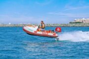 Family enjoying a self-drive boat ride with Ain Dubai in the background