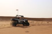 Polaris RZR dune buggy racing through the Dubai desert