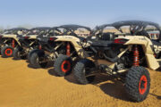 Fleet of Can-Am dune buggies ready for adventure in the desert.