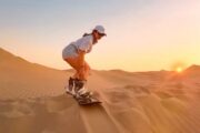 Tourist riding a camel in the Arabian desert