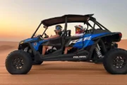 Family enjoying a Polaris RZR XP 1000cc 4-seater dune buggy ride in the desert.