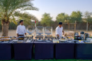 A well-prepared outdoor breakfast buffet with chefs serving guests.