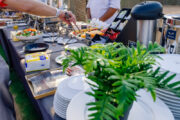 A breakfast buffet spread with fresh fruits, pastries, and hot dishes in the desert.